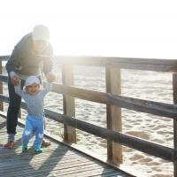 Au pair with child at the sea