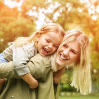 Au pair with child on her back